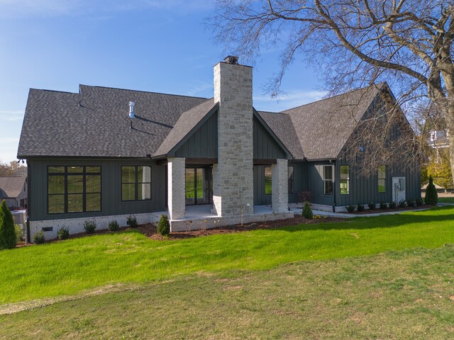 rear view of house with a lawn