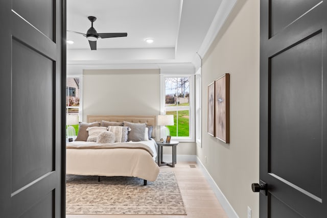 bedroom with ceiling fan and light hardwood / wood-style flooring