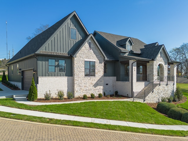 view of front of property featuring a garage and a front lawn