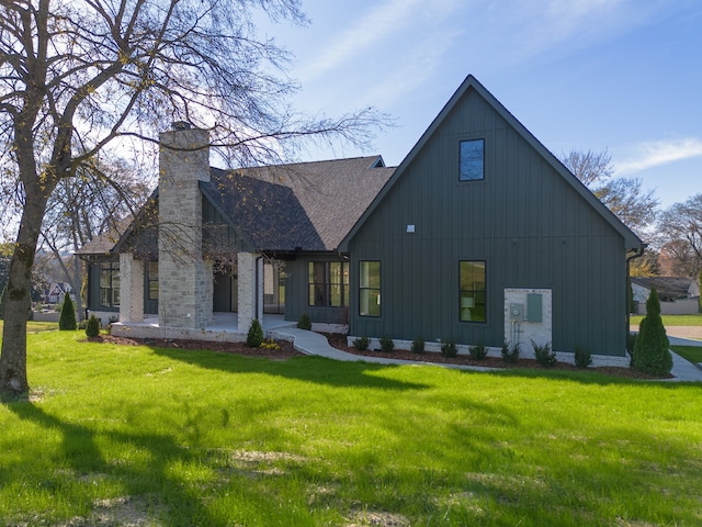 rear view of house featuring a yard