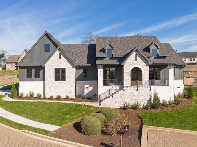 view of front of house with a porch and a front lawn