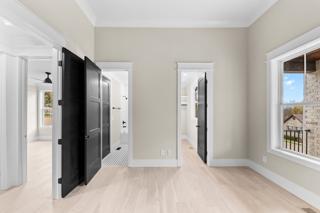 interior space featuring ceiling fan, a healthy amount of sunlight, crown molding, and light hardwood / wood-style flooring