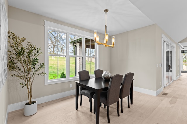 dining room featuring an inviting chandelier and light hardwood / wood-style flooring