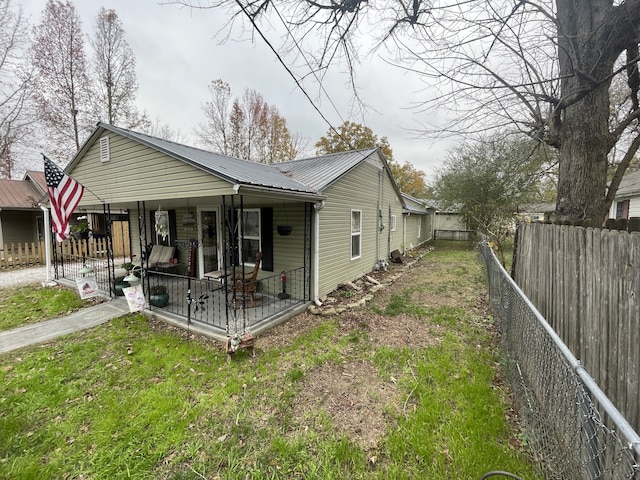 exterior space featuring a porch and a front yard