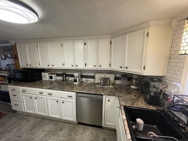 kitchen featuring stainless steel dishwasher, dark stone counters, dark wood-type flooring, sink, and white cabinetry