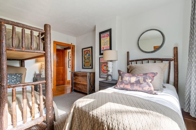 bedroom with dark hardwood / wood-style flooring