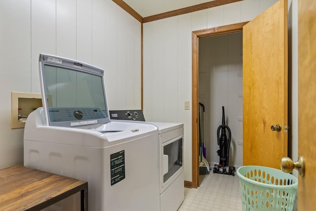 laundry area featuring washing machine and dryer and ornamental molding