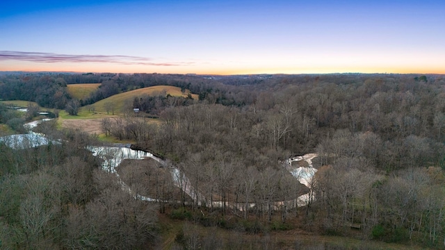 aerial view at dusk with a water view