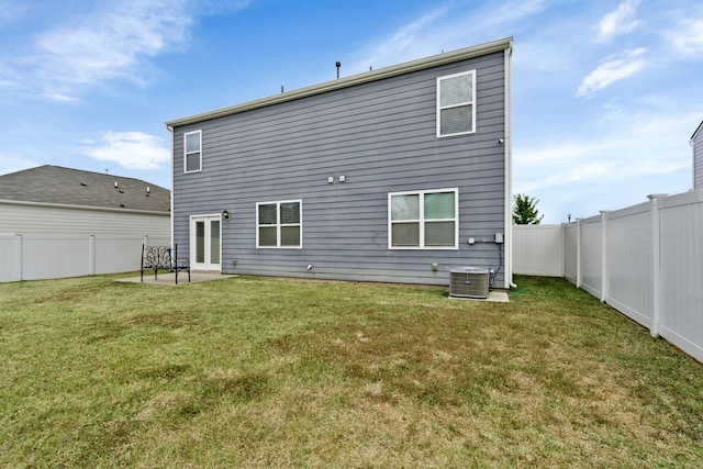 back of property featuring a lawn, a patio area, french doors, and central AC