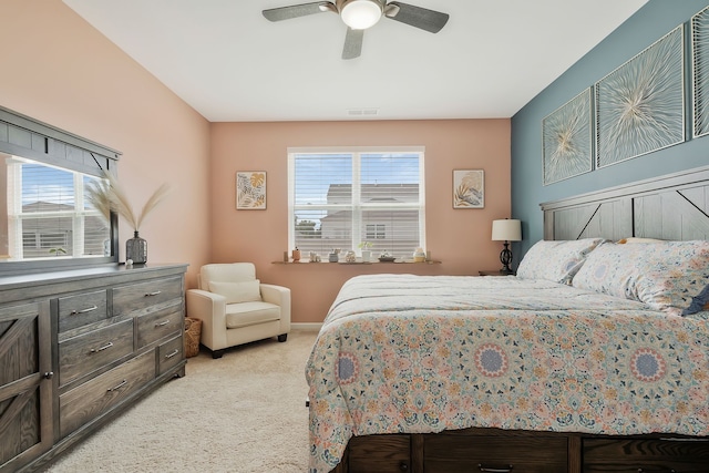 bedroom with light colored carpet, multiple windows, and ceiling fan