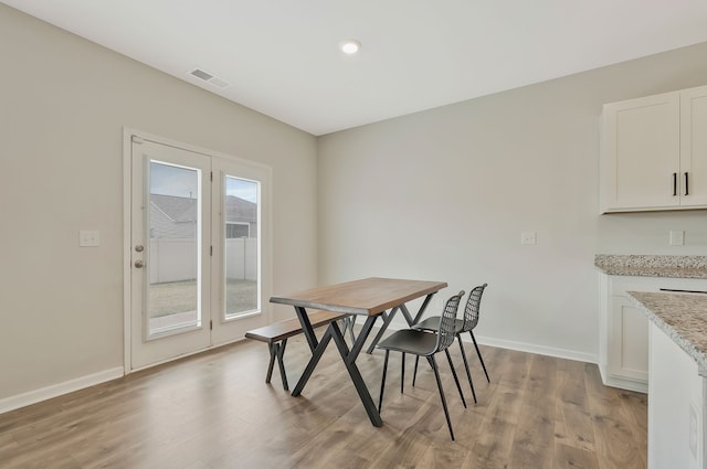 dining area featuring light wood-type flooring