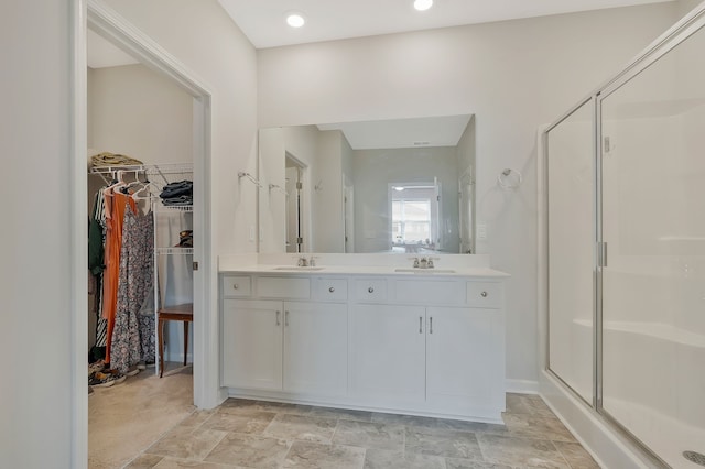 bathroom featuring vanity and a shower with shower door