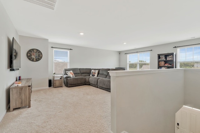 living room featuring light colored carpet and a wealth of natural light