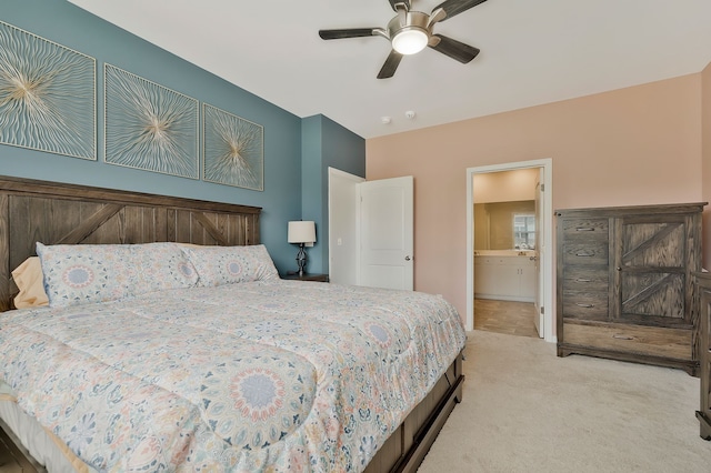 carpeted bedroom featuring ensuite bath and ceiling fan