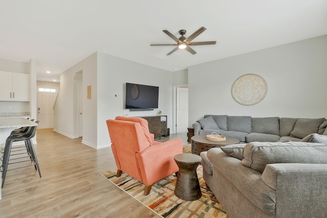 living room with ceiling fan and light wood-type flooring