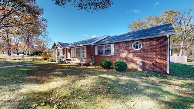 view of side of home featuring a lawn