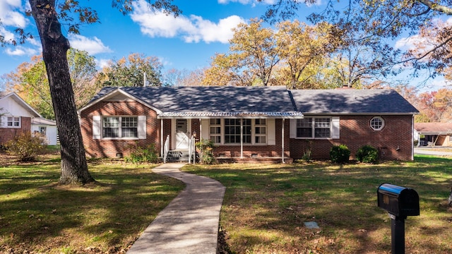 single story home featuring covered porch and a front yard