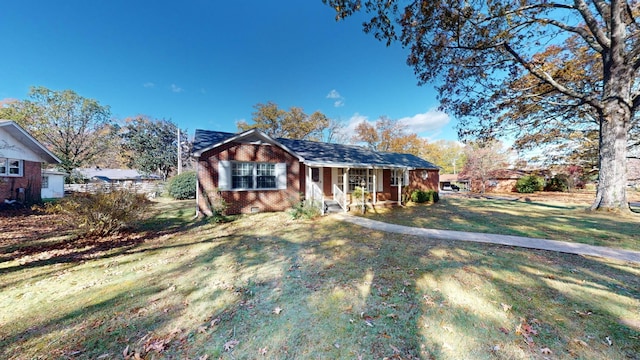 400 Edgewood Dr, Tullahoma, TN 37388 - ranch-style house with a porch, a front yard, and brick siding