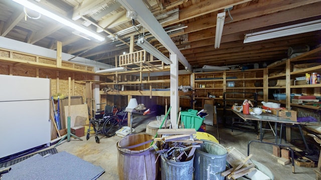 basement with white refrigerator