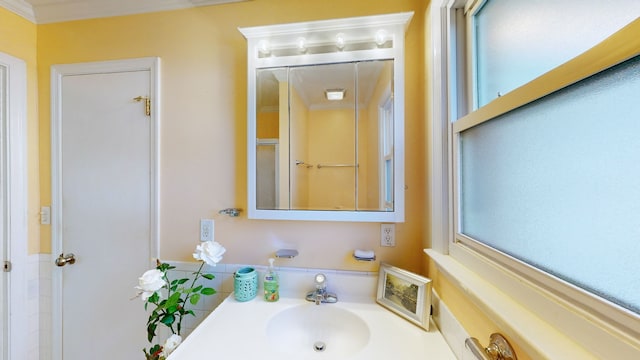 bathroom featuring crown molding and sink