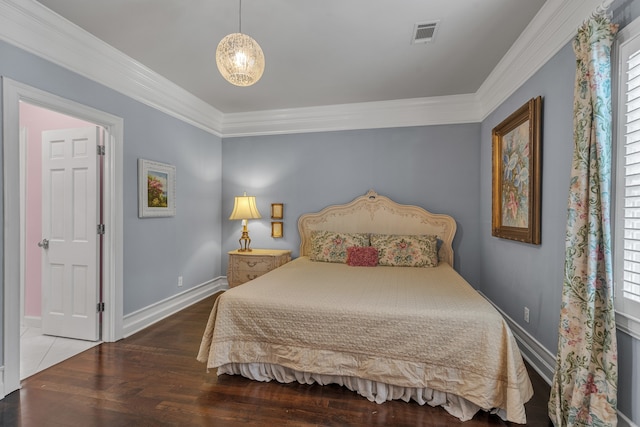 bedroom with crown molding and hardwood / wood-style flooring