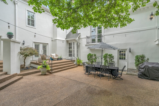 view of patio featuring grilling area, french doors, and outdoor dining space