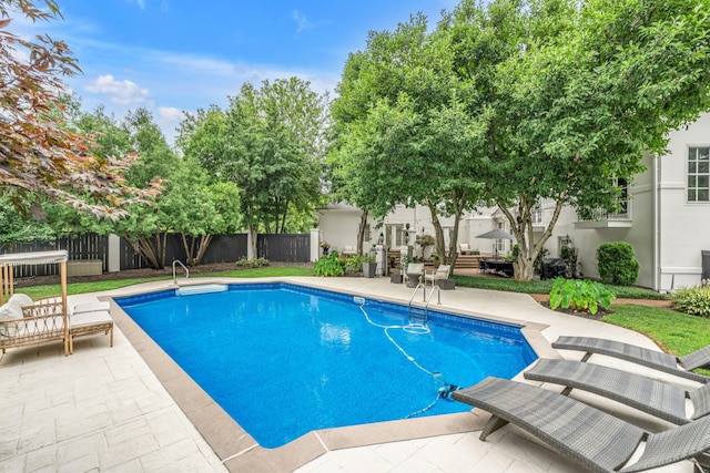 view of swimming pool with a patio area