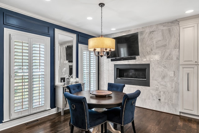 dining room featuring dark hardwood / wood-style flooring, plenty of natural light, and ornamental molding