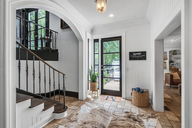 foyer entrance featuring crown molding