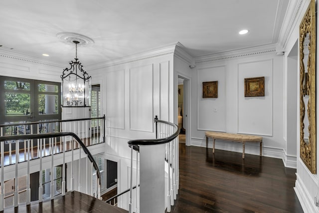 interior space with dark hardwood / wood-style flooring, a notable chandelier, and crown molding