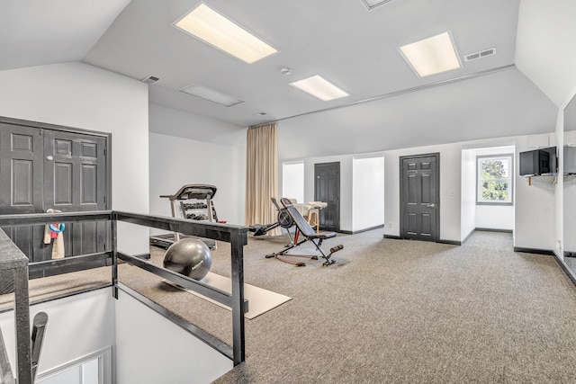 exercise area with lofted ceiling and light carpet