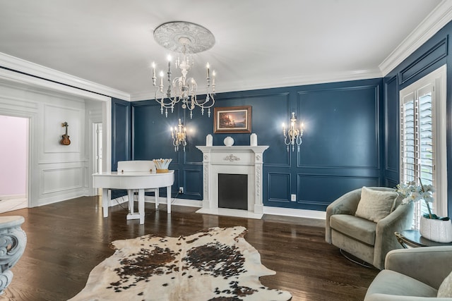 sitting room featuring crown molding, dark hardwood / wood-style flooring, and a notable chandelier