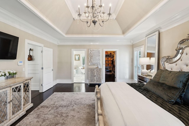 bedroom featuring dark wood-type flooring, a chandelier, a spacious closet, and ornamental molding