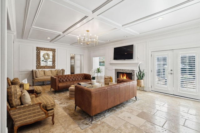 living room with coffered ceiling, a healthy amount of sunlight, and a decorative wall