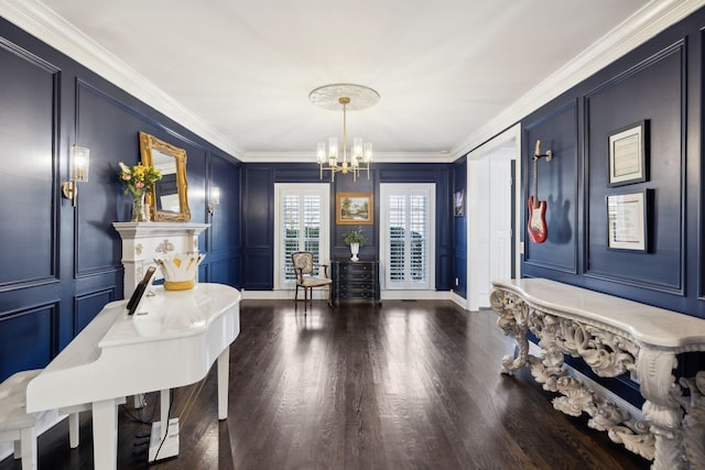 foyer entrance featuring a decorative wall, ornamental molding, dark wood-style flooring, and a chandelier