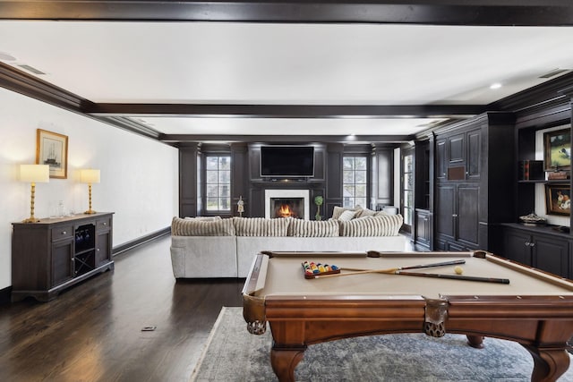 game room with a wealth of natural light, beamed ceiling, a glass covered fireplace, and dark wood-style floors