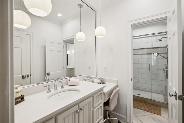 bathroom with tile patterned floors, a stall shower, ornamental molding, baseboards, and vanity