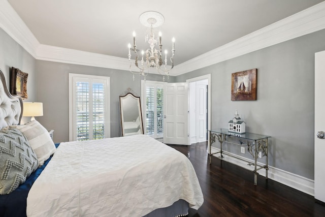 bedroom featuring baseboards, an inviting chandelier, wood finished floors, and crown molding