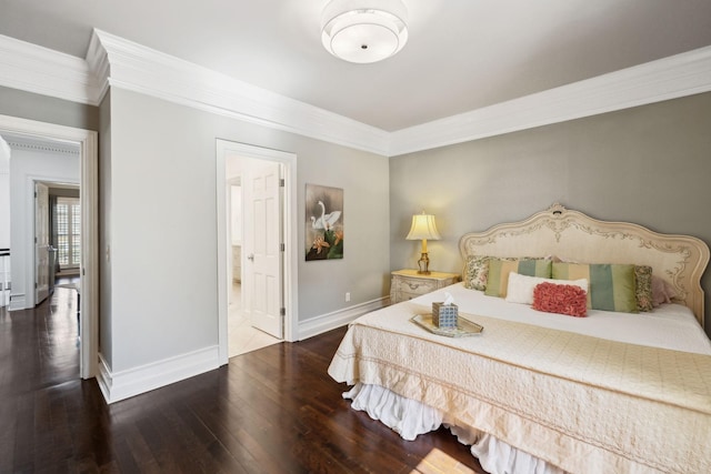 bedroom with baseboards, ensuite bath, crown molding, and hardwood / wood-style flooring