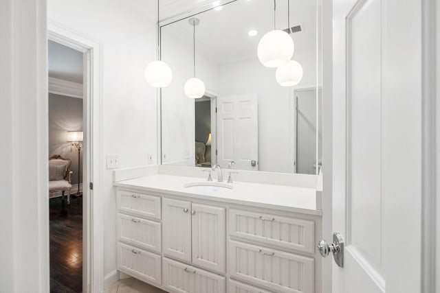 bathroom featuring visible vents, wood finished floors, connected bathroom, crown molding, and vanity