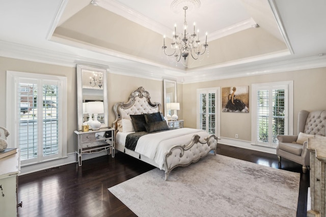 bedroom with multiple windows, a raised ceiling, an inviting chandelier, and dark wood finished floors