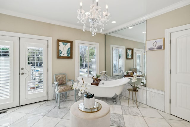 full bathroom with a freestanding tub, a notable chandelier, ornamental molding, recessed lighting, and tile patterned flooring