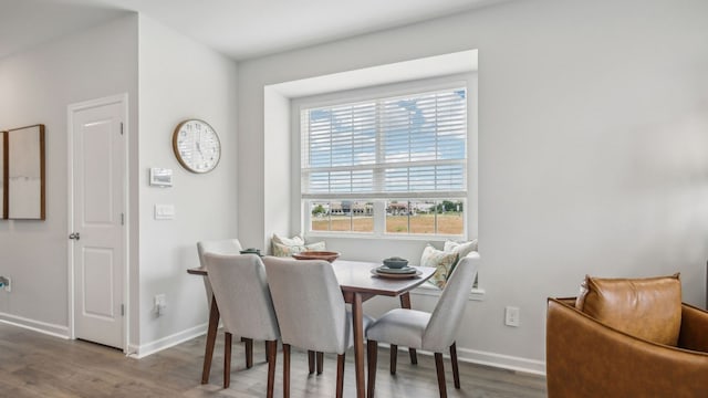 dining space with hardwood / wood-style flooring