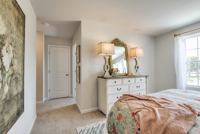 bedroom featuring light carpet