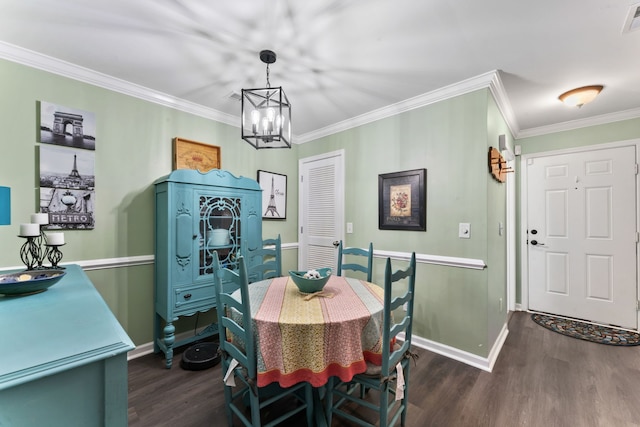 dining room with crown molding, dark wood-type flooring, and a chandelier