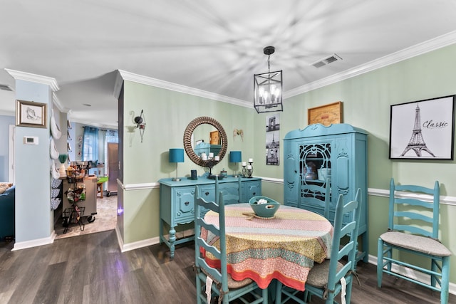 dining space with dark hardwood / wood-style floors, ornamental molding, and a chandelier