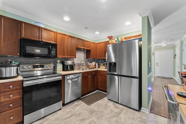 kitchen featuring appliances with stainless steel finishes, tasteful backsplash, crown molding, and sink