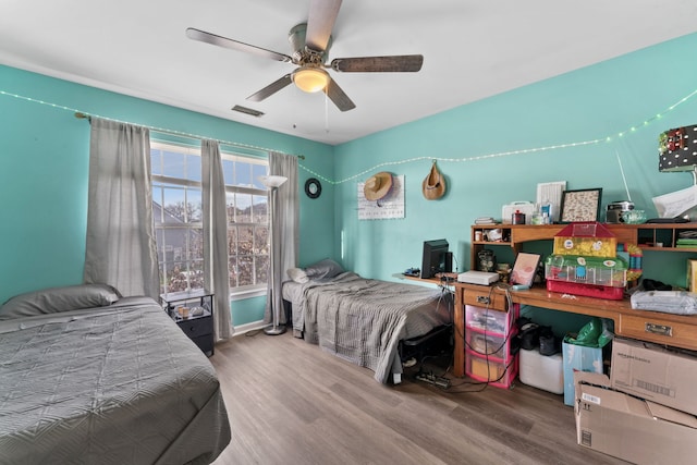 bedroom featuring ceiling fan and wood-type flooring