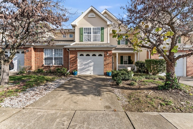 view of property with covered porch and a garage