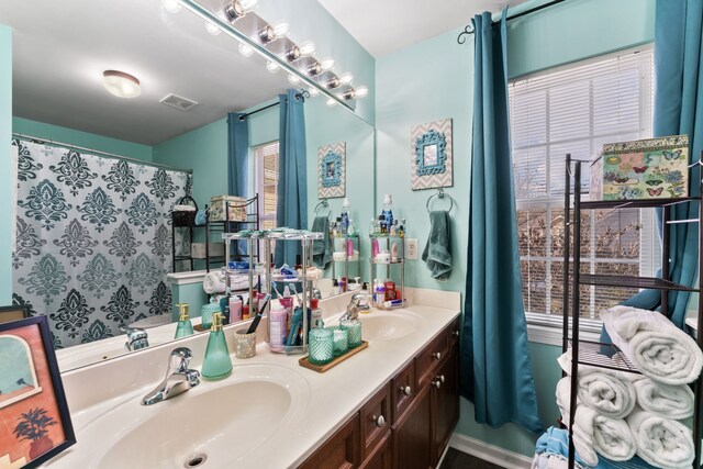 bathroom featuring vanity and a wealth of natural light